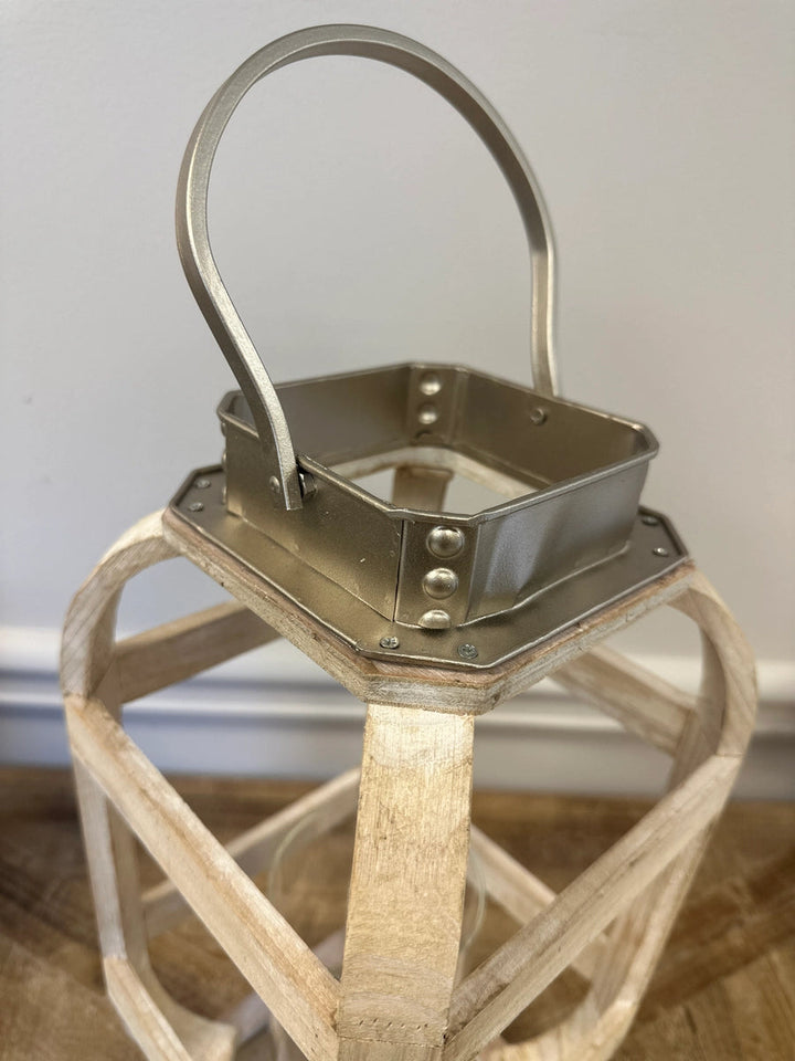 Close view of the squared metal collar and loop handle atop the white lantern