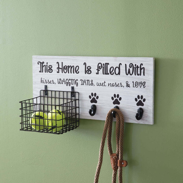 Wall-mounted Dog Leash Organizer with Hooks and Basket holding leashes and a basket storing tennis balls for pet convenience.