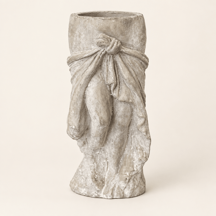 Draped skirt cement planter with sculpted waist tie on an ivory studio background