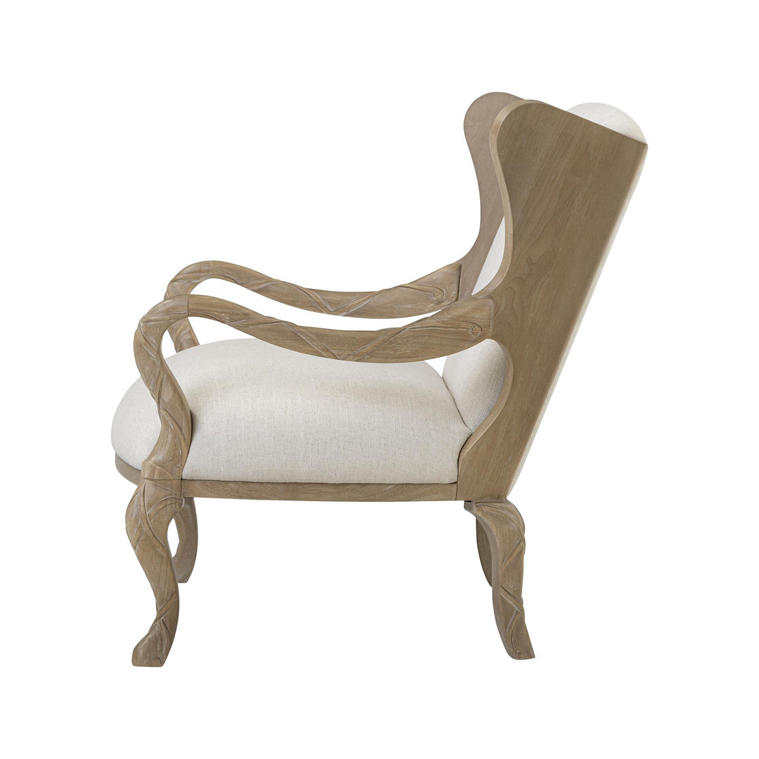 Side profile of the ivory upholstered armchair with its open ribbon-shaped arm.