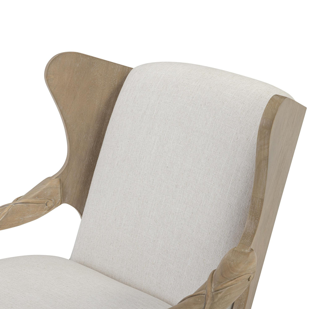 Close-up of ivory upholstery beside the warm driftwood back and arm details.