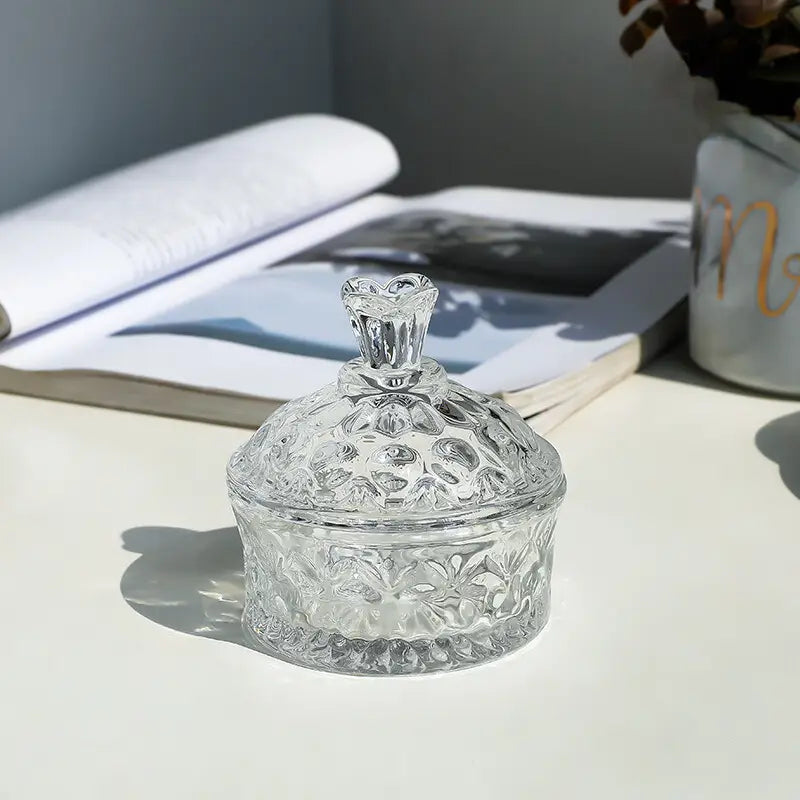 Clear floral glass jar styled beside an open book