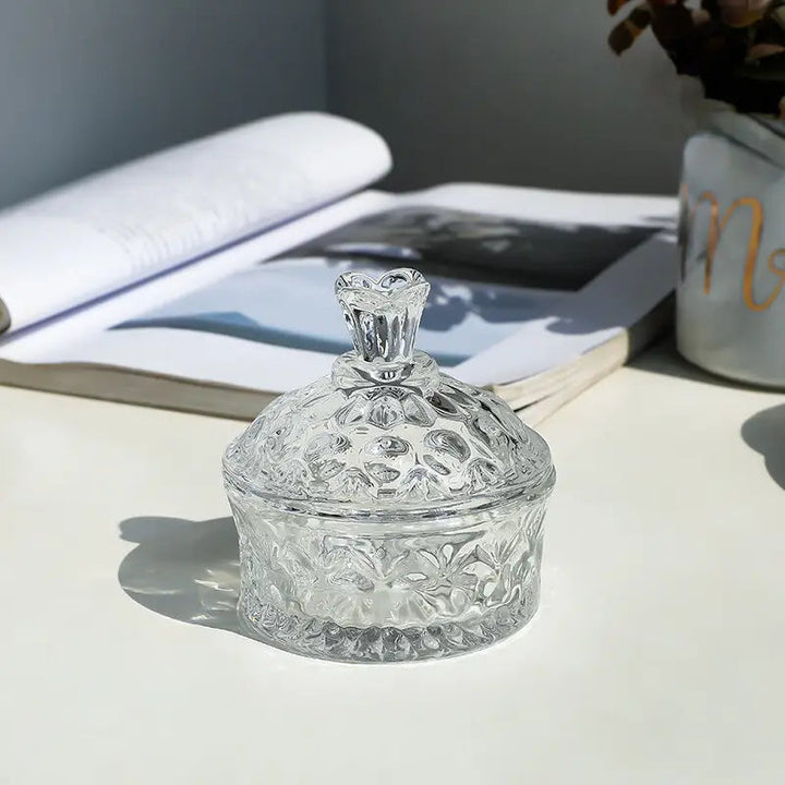 Clear floral glass jar styled beside an open book