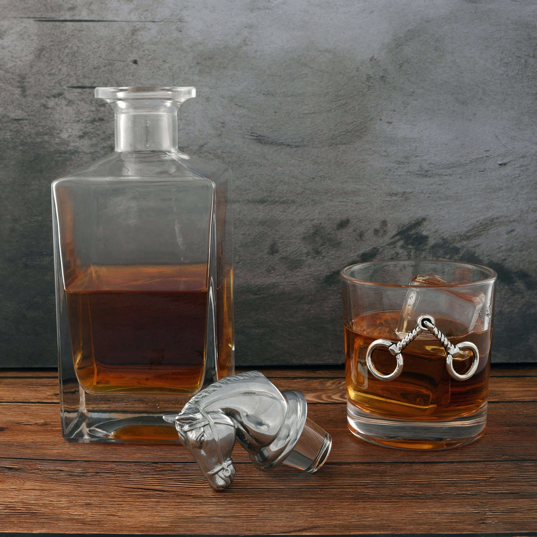 Equestrian Horse Head Whiskey Decanter Set on rustic table with glass of whiskey and elegant horse head stopper.