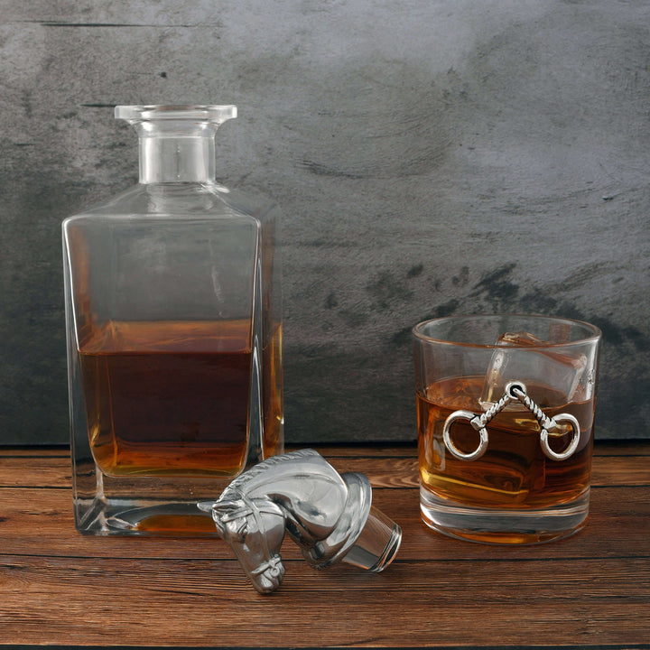 Equestrian Horse Head Whiskey Decanter Set on rustic table with glass of whiskey and elegant horse head stopper.