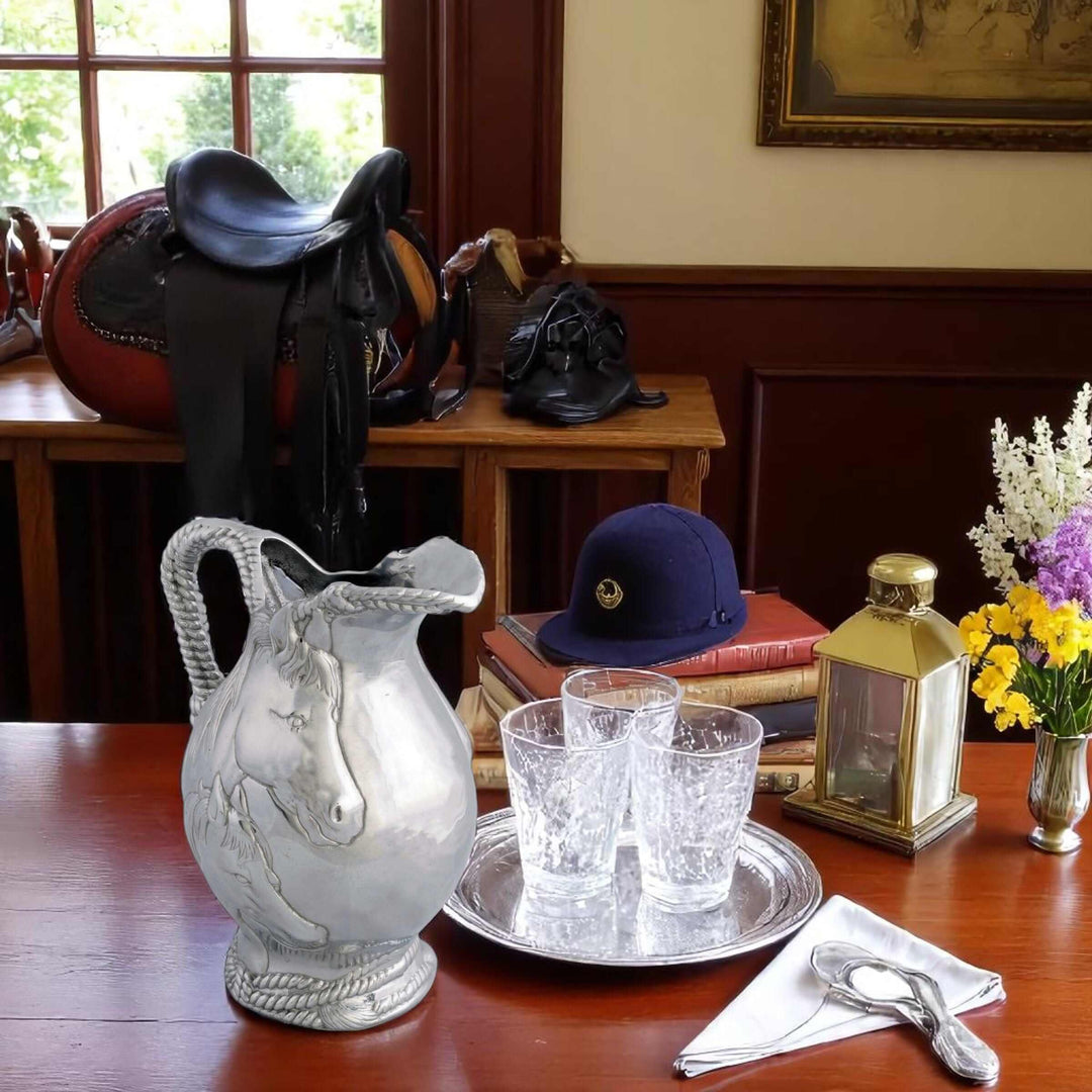 Equestrian Horse and Rope Pitcher with mare and foal design on table with equestrian gear.