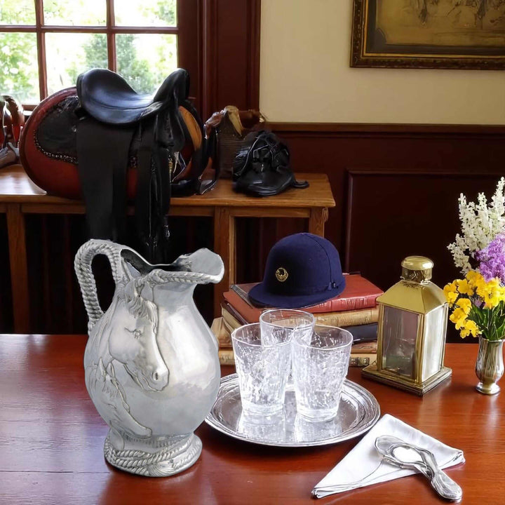 Equestrian Horse and Rope Pitcher with mare and foal design on table with equestrian gear.