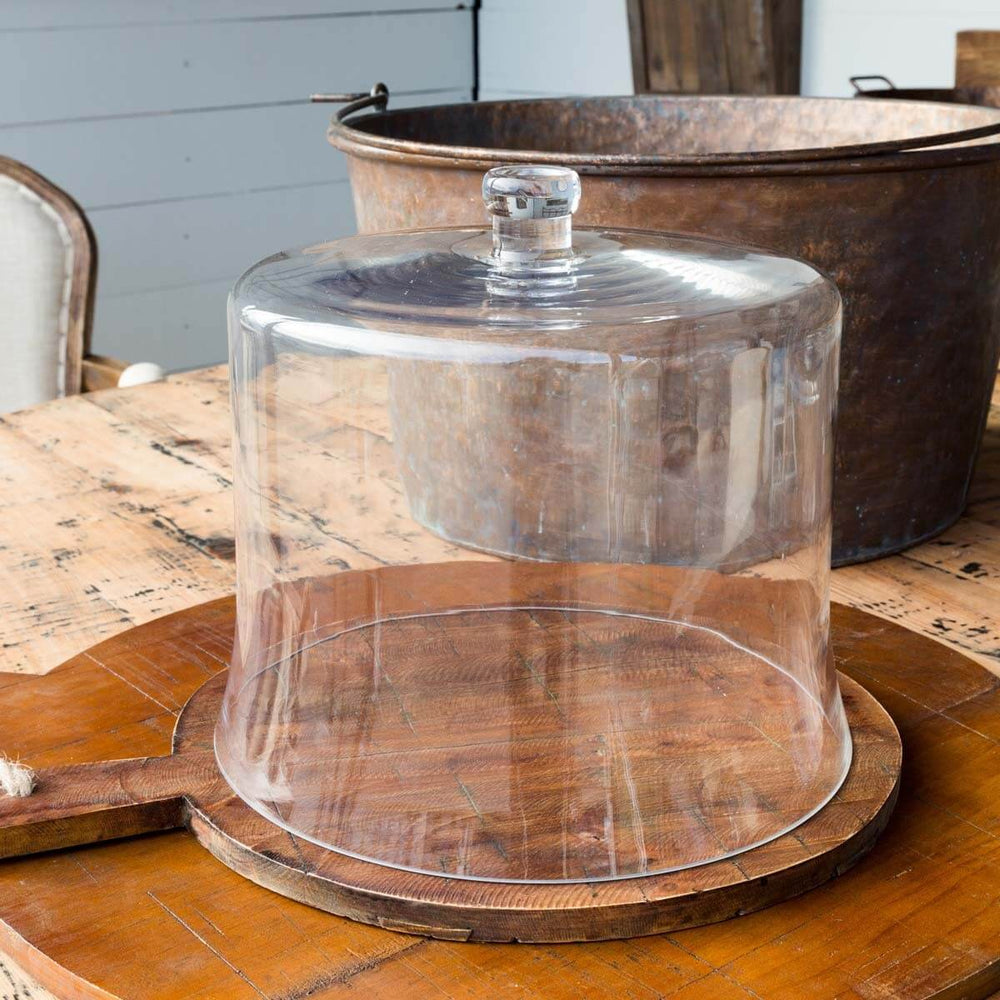 Extra Tall Glass Cloche for Multi-Tiered Cakes on rustic wooden table, perfect for showcasing elegant, layered desserts.