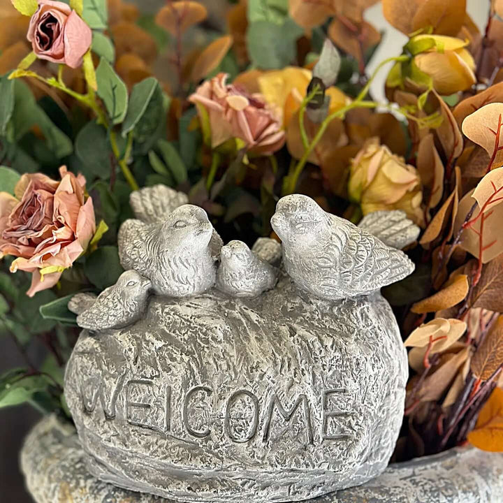 Vintage cement welcome sign with detailed birds and roses