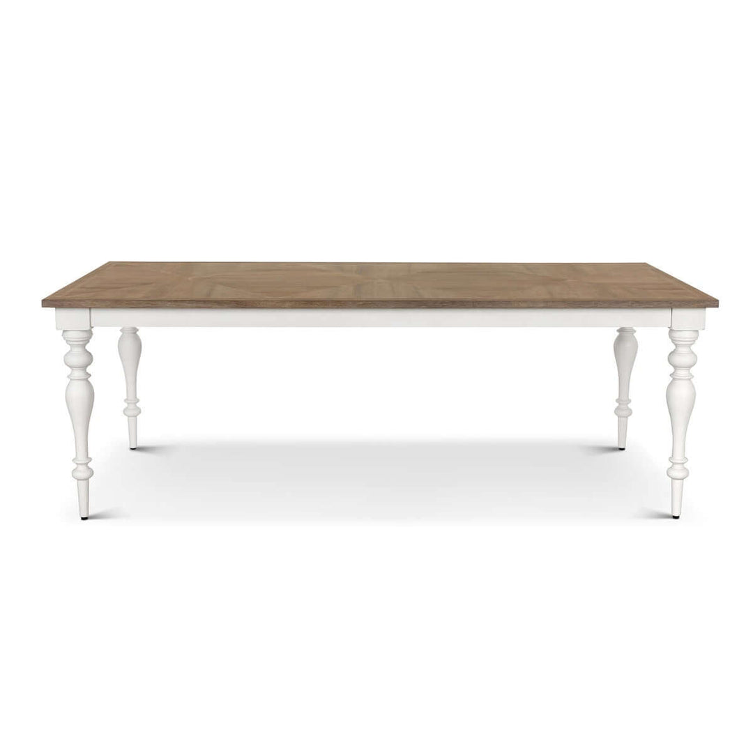 Farmhouse dining table with vintage white turned legs and richly grained wooden tabletop, ideal for countryside-inspired interiors.