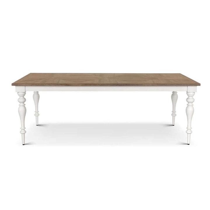 Farmhouse dining table with vintage white turned legs and richly grained wooden tabletop, ideal for countryside-inspired interiors.