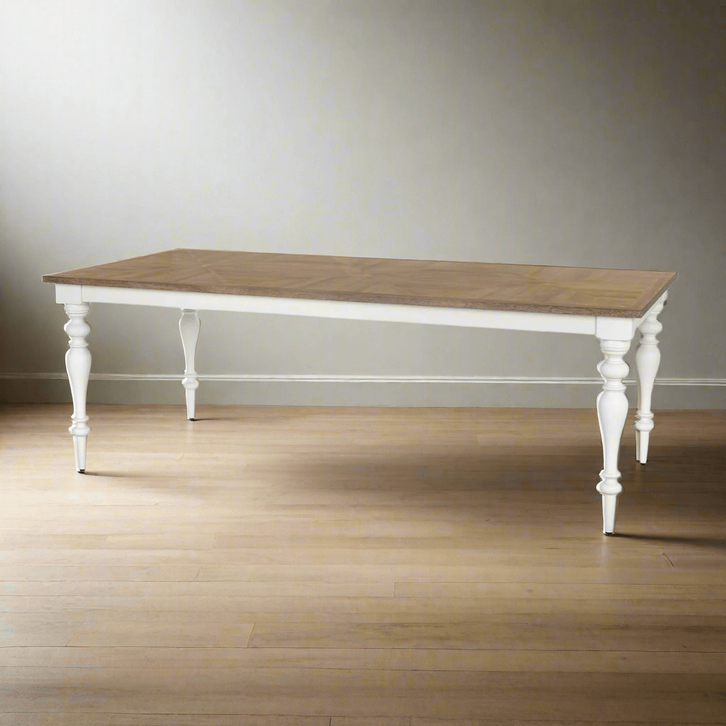 Farmhouse dining table with wood parquet top and vintage white turned legs, combining rustic charm and elegant design.