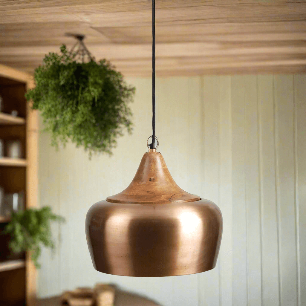 Farmhouse wood and satin brass pendant light, evoking candlelit warmth, with a natural wood top and golden brass glow in a cozy ambiance.