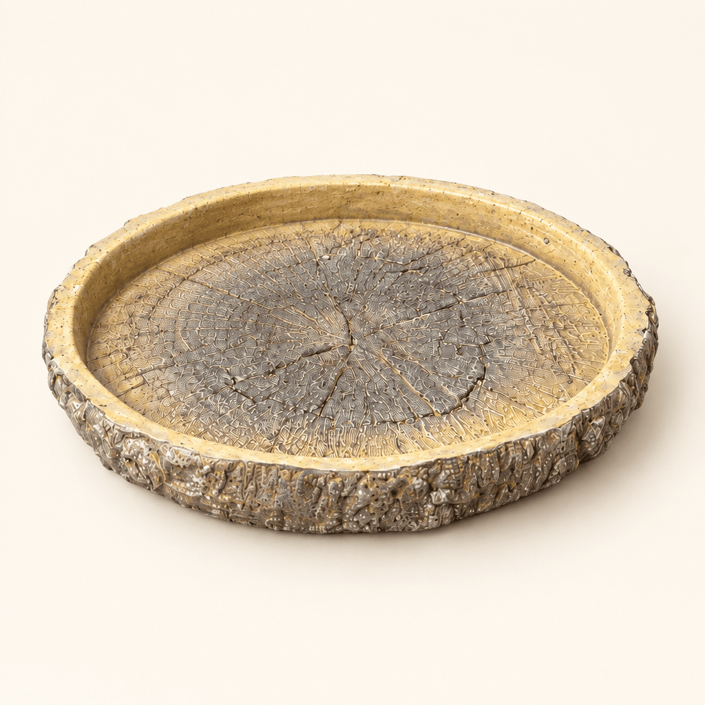 Faux bois cement dish with bark-textured edges and tree-ring detailing on an ivory background