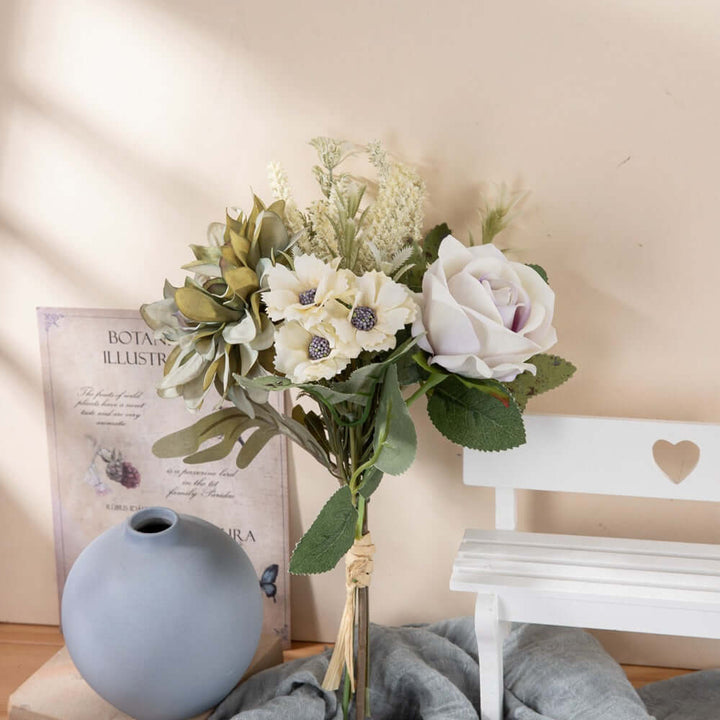 Faux flower bouquet featuring delicate roses and garden blooms in a soft color palette, styled with a rustic vase.