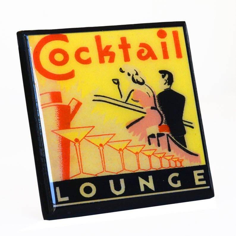 Decorative coaster with 'Cocktail Lounge' text and cocktail-themed graphics on a yellow background.