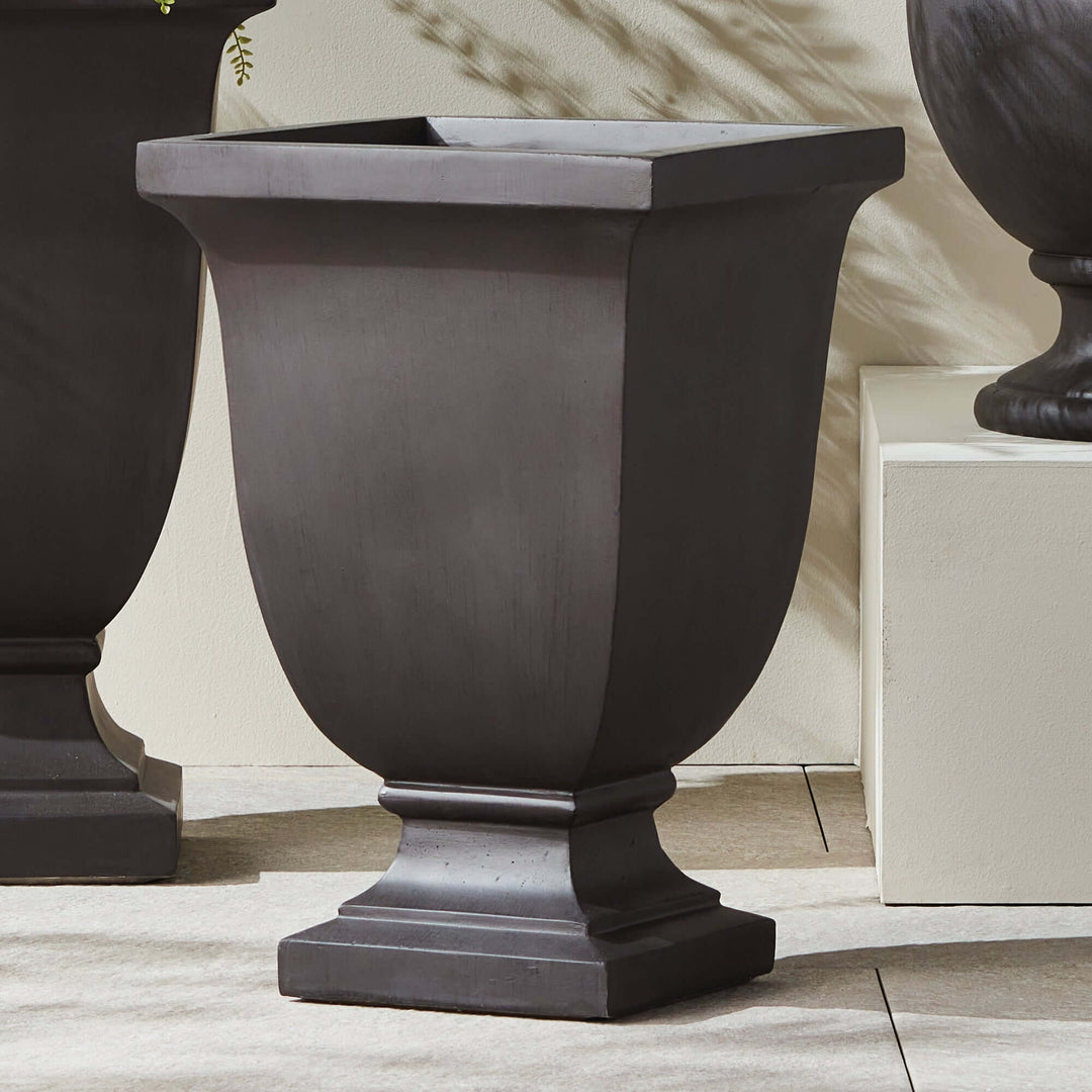 Fibreclay footed planter in charcoal finish, featuring classic urn design for vintage outdoor garden decor.