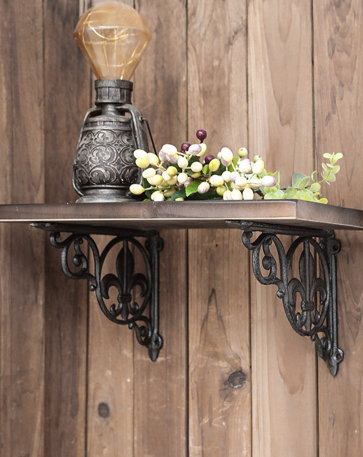 Fleur-de-Lis Cast Iron Shelf Brackets supporting a rustic wood shelf