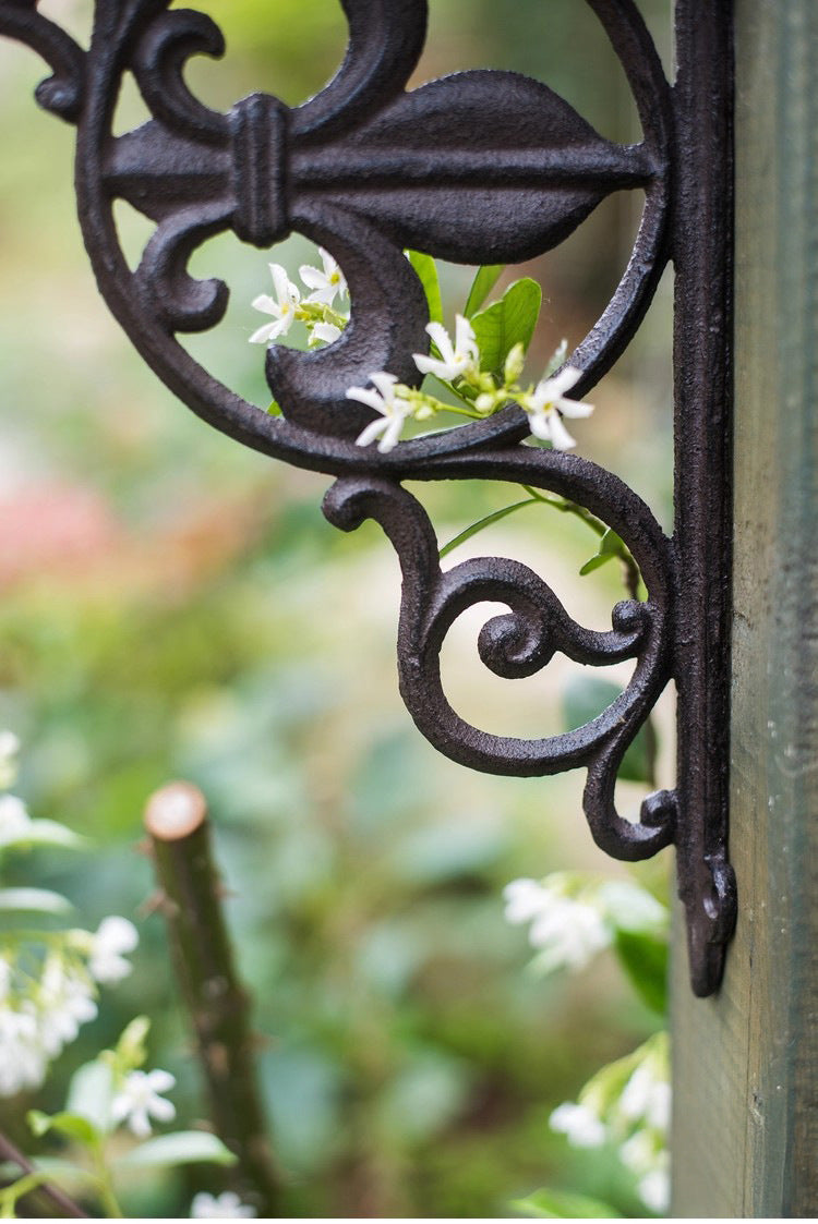 Close view of floral scrollwork on a cast iron shelf bracket