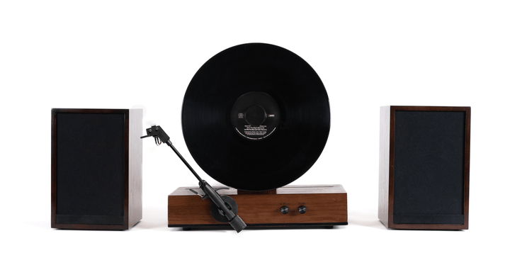Turntable with vinyl record and speakers on a white background