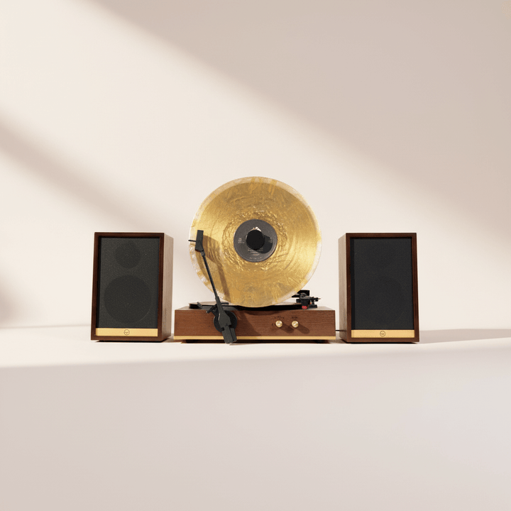 Vintage record player with gold platter and speakers on a white surface