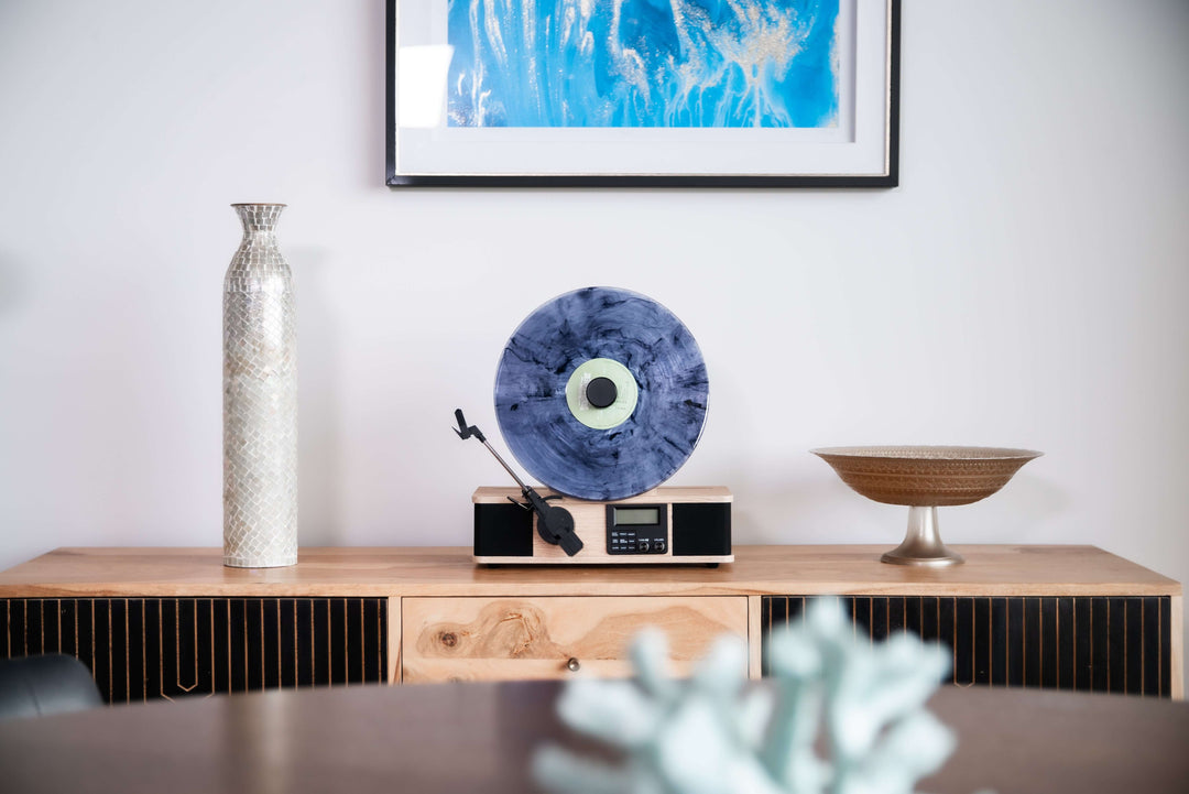 Wooden console table with decorative items including a vase, bowl, and record player.