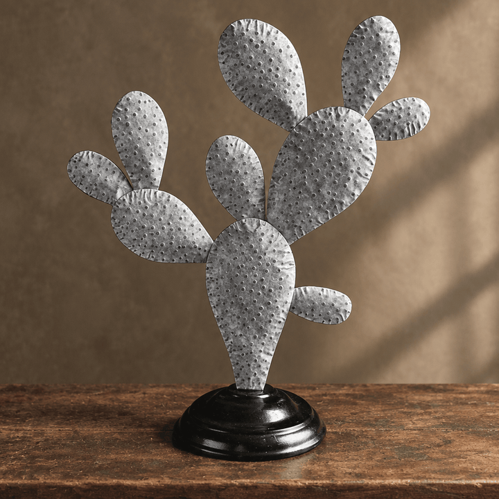 Close view of the pressed dotted silver metal detailing on a prickly pear cactus sculpture.
