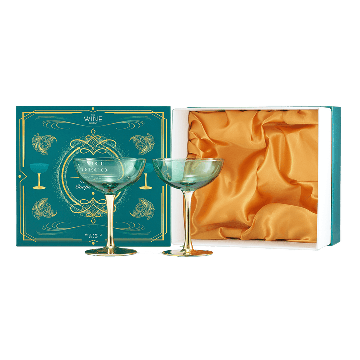 Two green wine glasses in a decorative box with gold accents