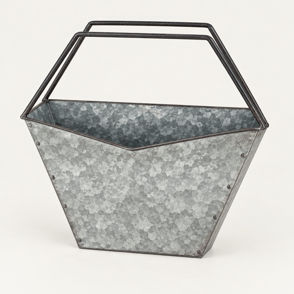 Empty geometric galvanized metal basin with dark iron wire uprights on an ivory studio background