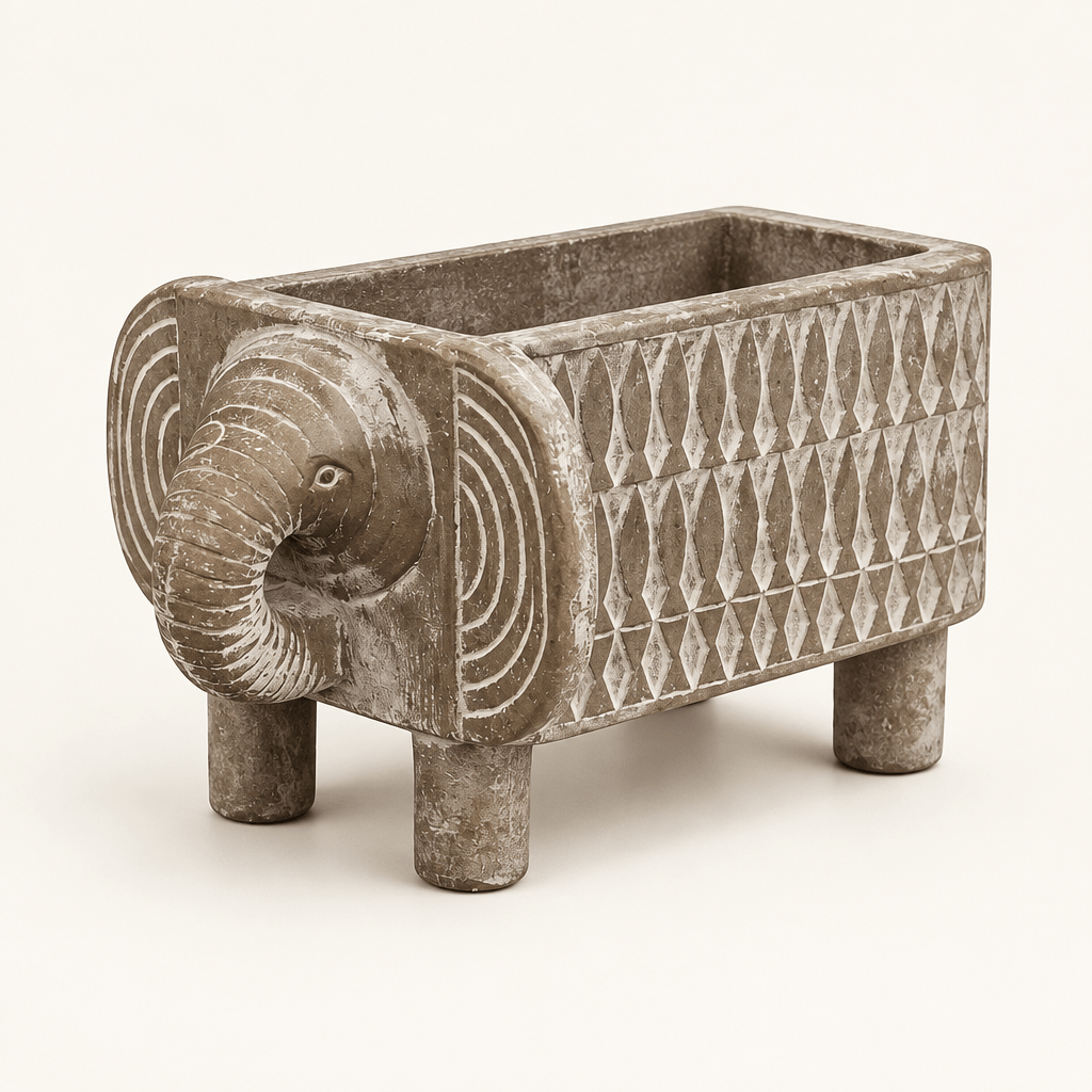 Weathered gray-taupe resin elephant planter with a curled trunk and pale geometric sides on an ivory background