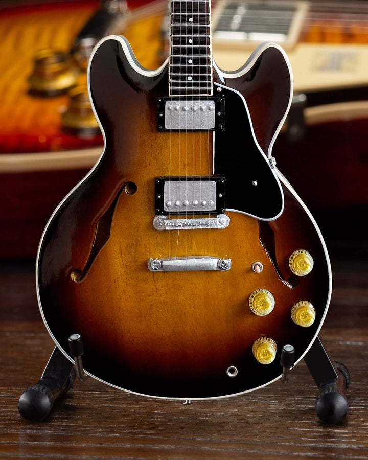 Gibson ES-335 Vintage Sunburst Mini Guitar Replica on display, showcasing detailed craftsmanship of classic 1958 model.