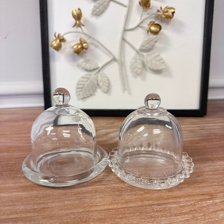 Glass Display Cloches with Bases styled with small objects and candlelight