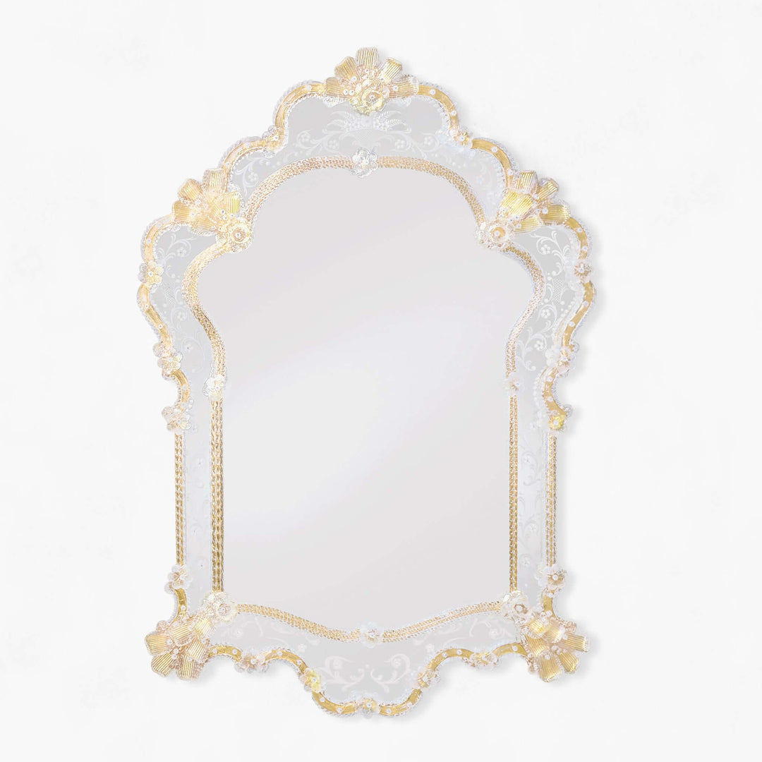 Decorative mirror with gold frame and floral details on a white background