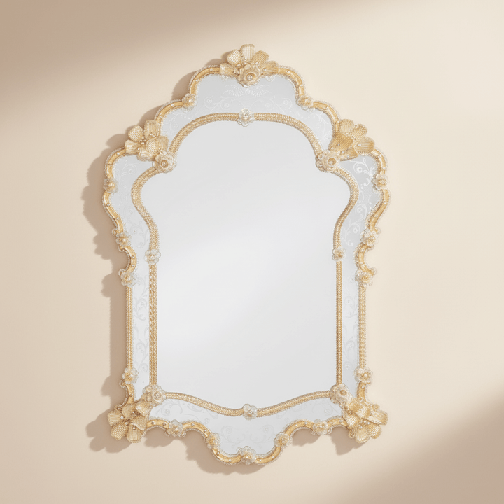 Decorative wall mirror with gold frame on a beige background