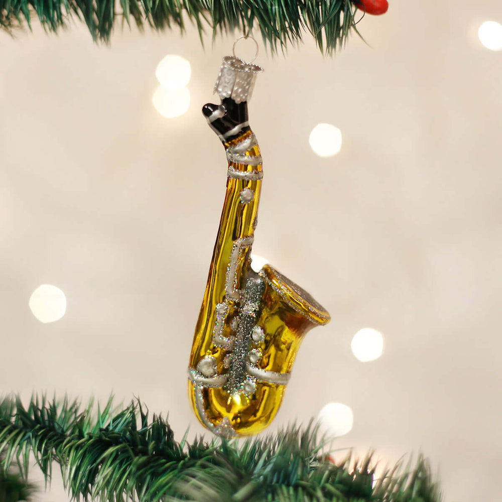Gold Glass Saxophone Christmas Ornament hanging on a tree, capturing the musical elegance and charm of the saxophone in festive decor.