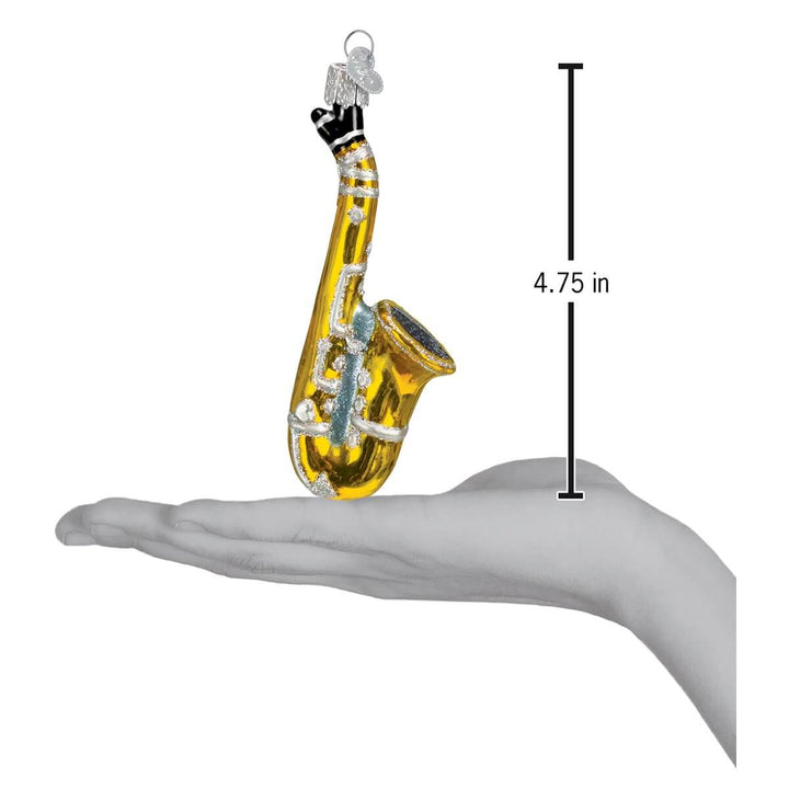 Gold Glass Saxophone Christmas Ornament held in hand, measuring 4.75 inches. A tribute to musical elegance and charm.