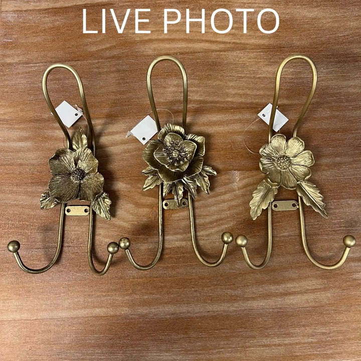Live supplier photo of all three gold iron flower wall hook designs together