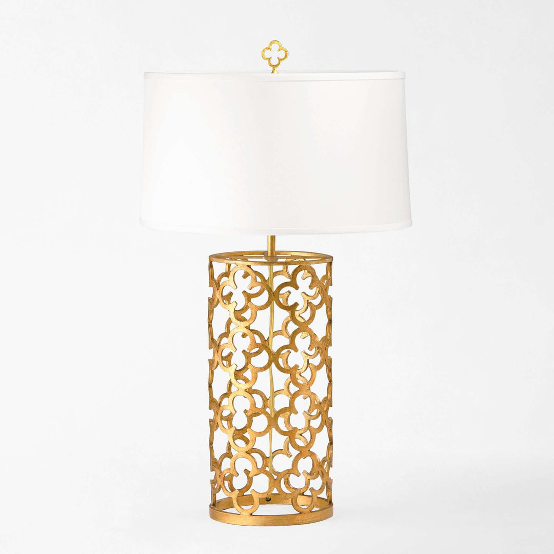 Gold decorative lamp with white shade on a white background