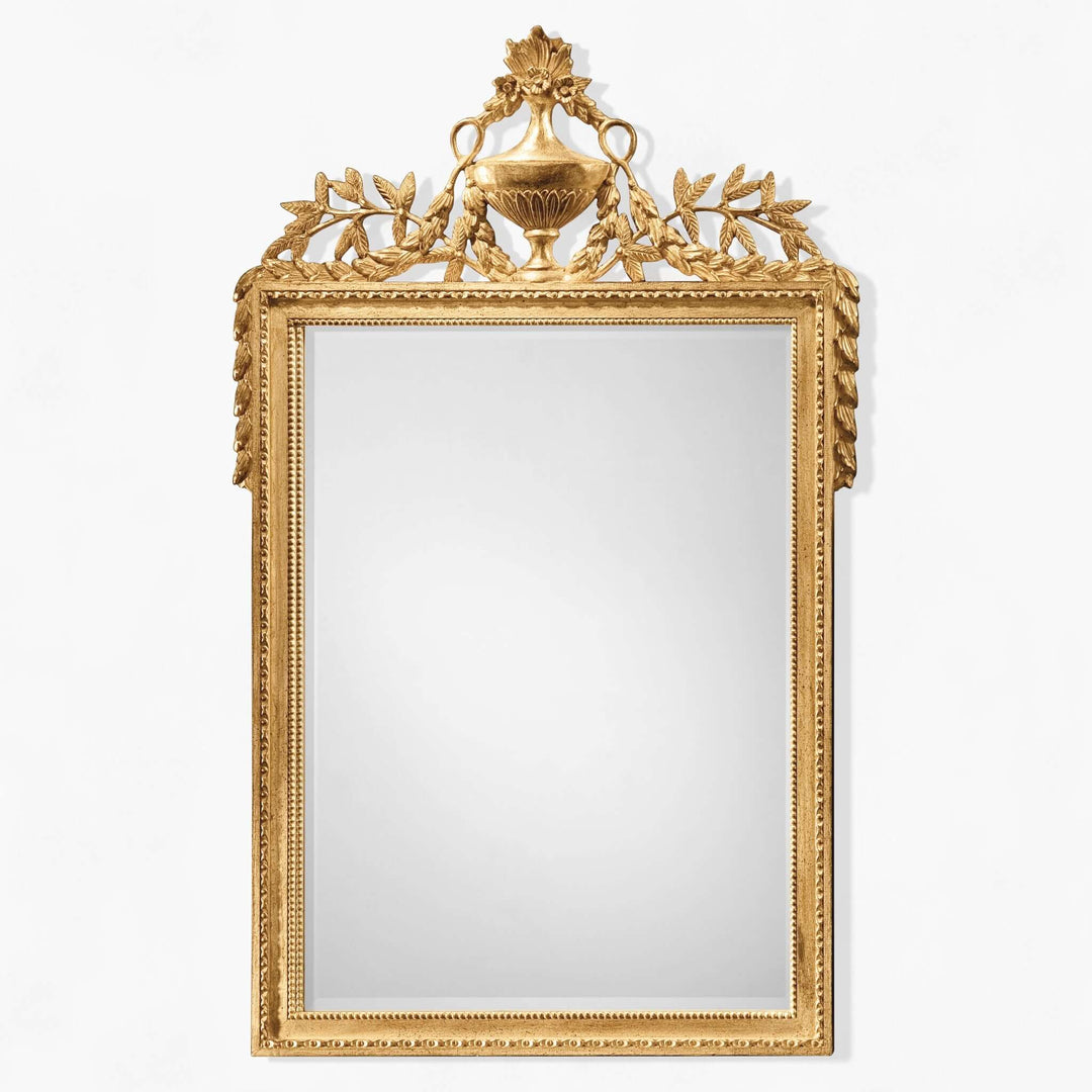 Decorative gold-framed mirror on a white background