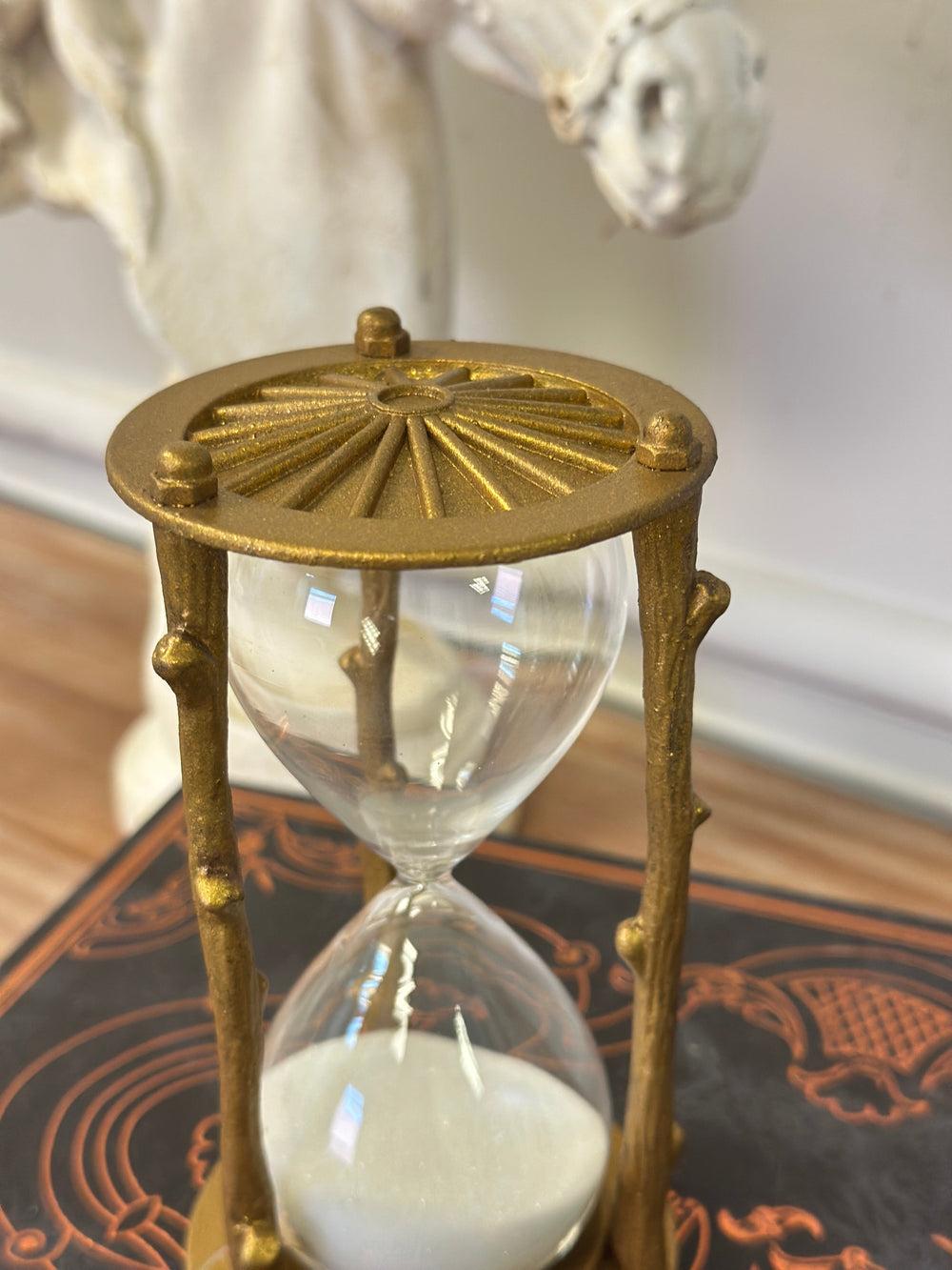 Top view of the golden branch hourglass showing the radiating metal cap