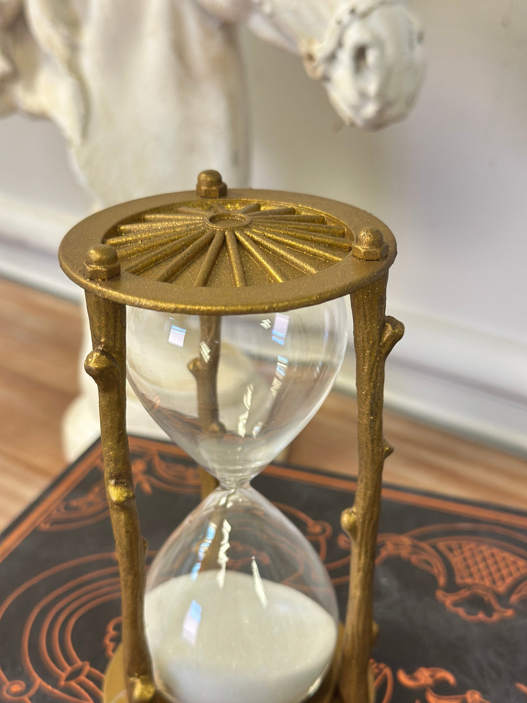 Top view of the golden branch hourglass showing the radiating metal cap