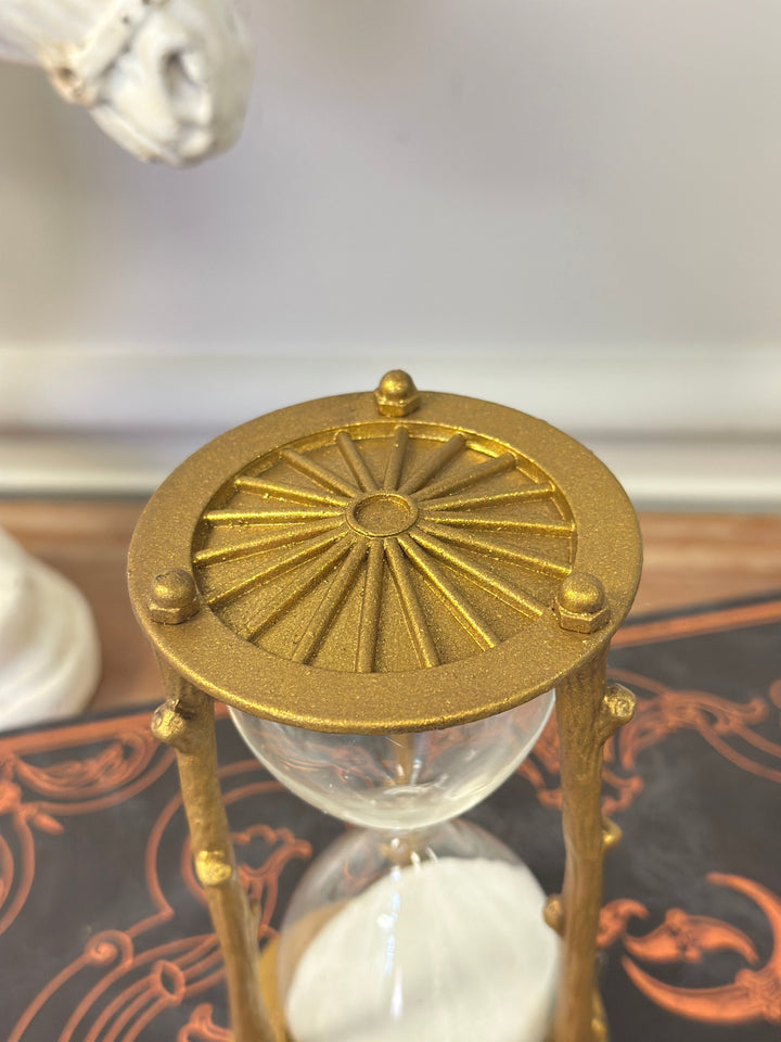 Overhead detail of the gold hourglass frame and sculpted branch texture
