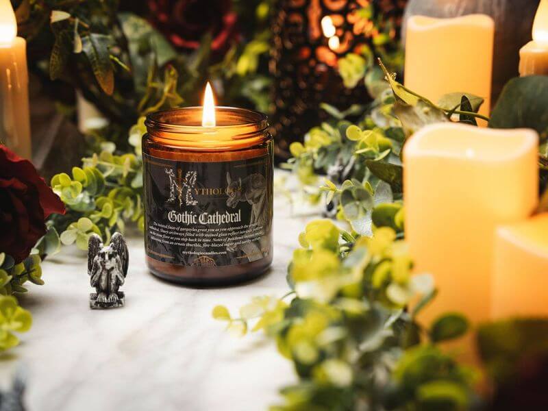 Gothic Cathedral Candle surrounded by lush greenery and glowing lights, evoking medieval sanctuary mystery.