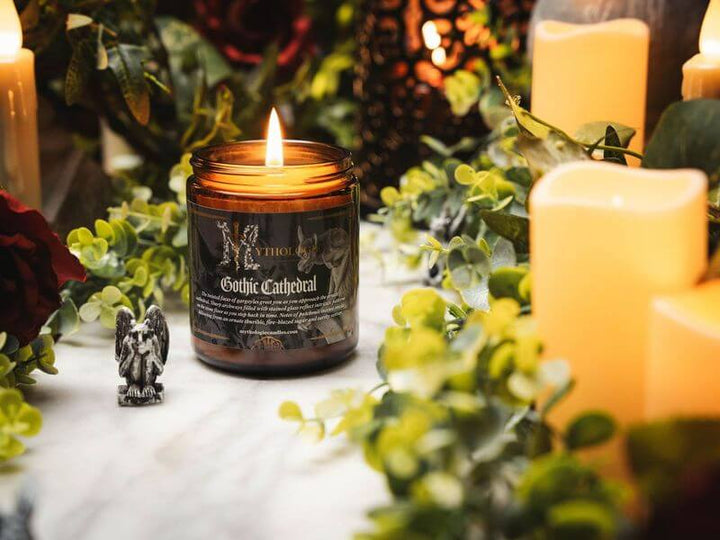 Gothic Cathedral Candle surrounded by lush greenery and glowing lights, evoking medieval sanctuary mystery.
