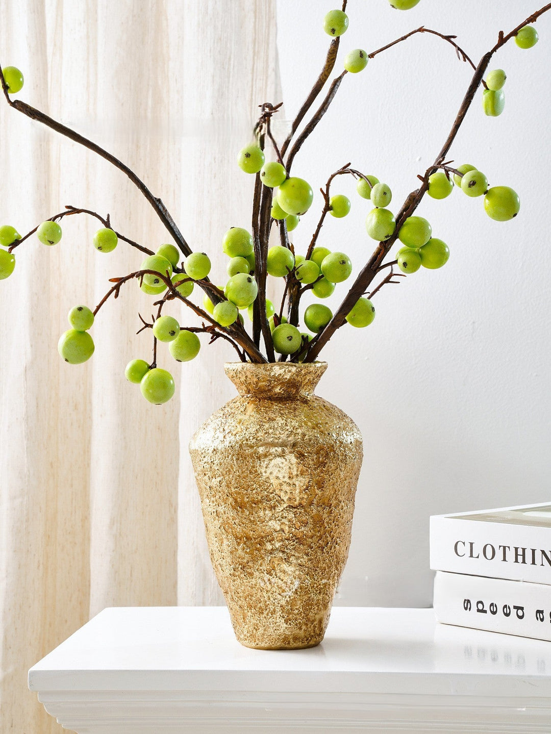 Tall Hammered Gold Decorative Vase holding leafy branches