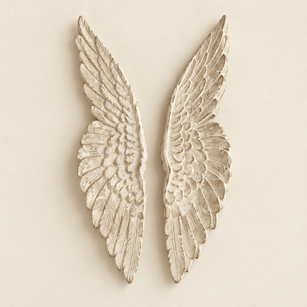 Pair of distressed wooden angel wings against an ivory wall