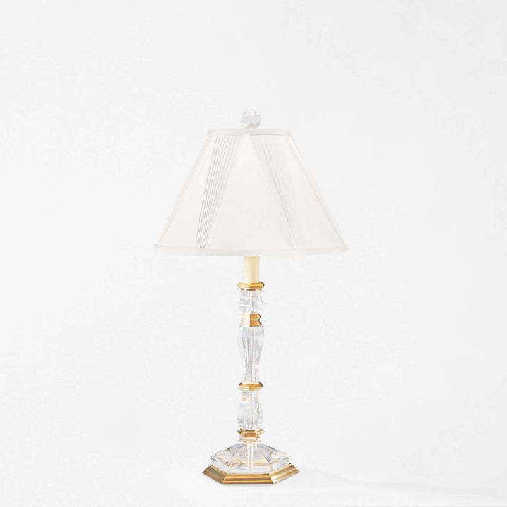 Decorative table lamp with a white shade on a white background