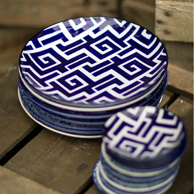 Four blue and white Moroccan plates arranged as a complete set