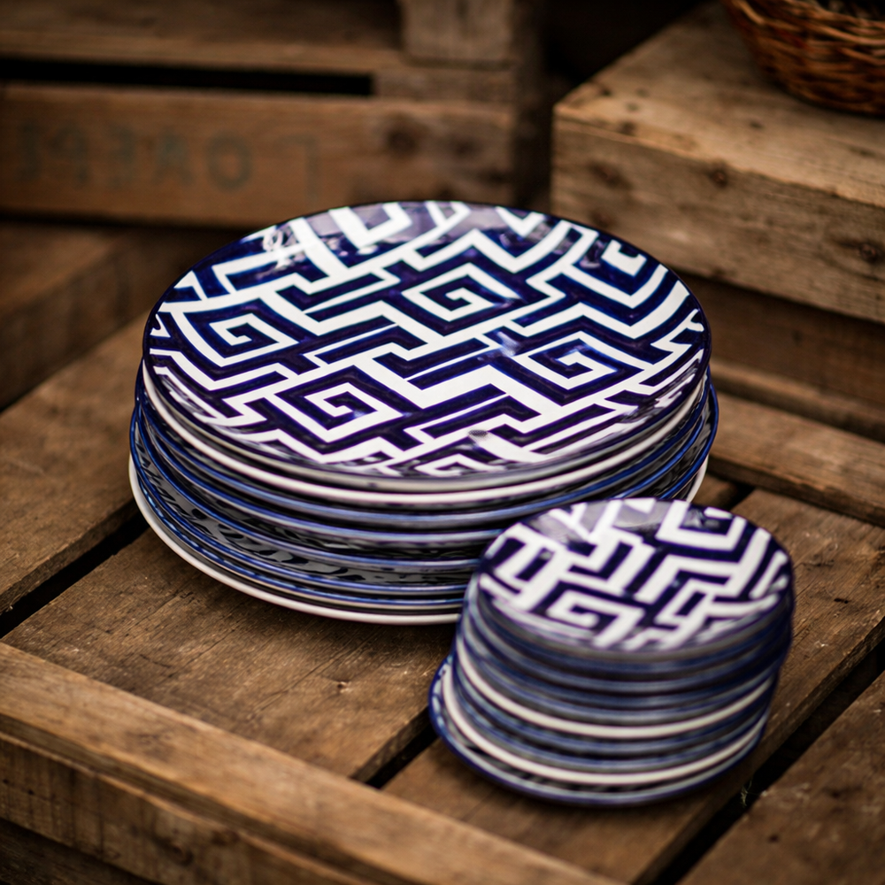 Hand-painted blue geometric border on an eight-inch ceramic plate