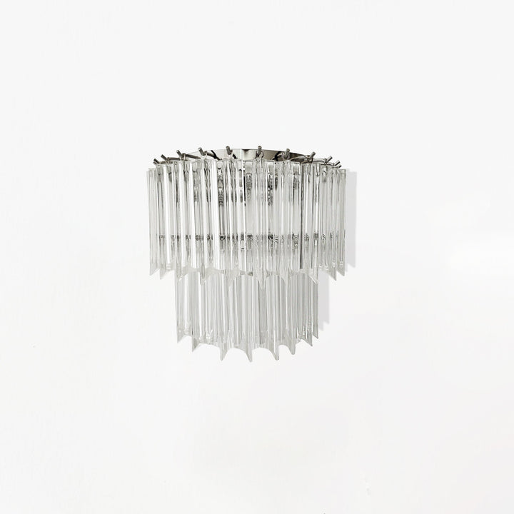 Wall sconce with clear glass and metal frame on a white background
